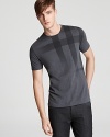 Burberry Brit sets the tone with a clever tee rendered with a faded tonal check pattern for iconic style.