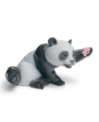 Jollier than the average bear, this Lladro panda figurine sits back and admires a fresh-picked flower in premium glazed porcelain. Jollier than the average bear, this Lladro panda figurine sits back and admires a fresh-picked flower in premium glazed porcelain.