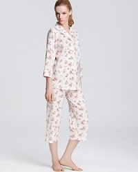 Lounge around in style with this classic three-quarter sleeve top and capri pajama pants featuring a pretty floral print. Lounge around in style with this classic three-quarter sleeve top and capri pajama pants featuring a pretty floral print.