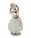 A baby herself, this pig-tailed cutie smothers her new puppy with love. Wearing blue bows in her hair and a floral-patterned skirt, this Lladro figurine warms the heart of any collector.