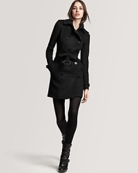Burberry London's military-inspired coat flaunts a belted waist for a sleek, slimming silhouette. Burberry London's military-inspired coat flaunts a belted waist for a sleek, slimming silhouette.