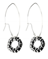 A charming touch. Nine West's traditional hoop earrings add an extra touch of chic style with a textured cut-out circle charm. Crafted in silver tone mixed metal. Approximate drop: 2-1/2 inches. A charming touch. Nine West's traditional hoop earrings add an extra touch of chic style with a textured cut-out circle charm. Crafted in silver tone mixed metal. Approximate drop: 2-1/2 inches.