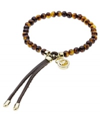 Slip-on stackable style! Michael Kors' chic stretch bracelet brings natural appeal with tortoise acetate beads and gold tone brass accents. Finished with gold-tone tipped, adjustable leather clasp. Approximate diameter: 2-1/4 inches. Slip-on stackable style! Michael Kors' chic stretch bracelet brings natural appeal with tortoise acetate beads and gold tone brass accents. Finished with gold-tone tipped, adjustable leather clasp. Approximate diameter: 2-1/4 inches.