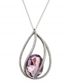 Look pretty in pink with Swarovski's blush crystal pendant necklace. Made in silver tone mixed metal, a chic caged design and sparkling crystal accents set it apart. Approximate length: 16-1/2 inches. Approximate drop: 3/4 inch.