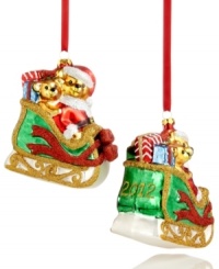 Two fun-loving bears get in the spirit, taking a ride on Santa's sleigh. Stacked with gifts and sparkling with glitter, this Holiday Lane ornament makes every Christmas merry. Shown front and back. Two fun-loving bears get in the spirit, taking a ride on Santa's sleigh. Stacked with gifts and sparkling with glitter, this Holiday Lane ornament makes every Christmas merry. Shown front and back.