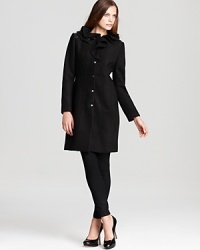 Balancing military tailoring with feminine ruffles, this T Tahari coats earns instant fashion stripes with a look that decidedly more hers than his. Balancing military tailoring with feminine ruffles, this T Tahari coats earns instant fashion stripes with a look that decidedly more hers than his.
