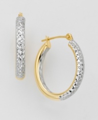 An unique design for classic hoop earrings. Two-tone 14k gold oval-shaped earrings feature a glimmering diamond-cut exterior. Interiors are polished for extra shine. An unique design for classic hoop earrings. Two-tone 14k gold oval-shaped earrings feature a glimmering diamond-cut exterior. Interiors are polished for extra shine.