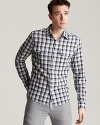 Featuring a tailored slim fit for a modern silhouette, this Michael Kors shirt hits the mark with a handsome square check pattern and 2 military-inspired chest pockets.