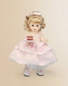 This pretty blonde miss brings birthday wishes to a lucky young lady on her special day.8 cloth dollDressed in a pink, tiered, lace-trimmed frock and white Mary Jane slippersShe offers a luscious-looking slice of birthday cakeRecommended for ages 3 and upImported