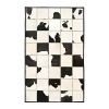 The bold black and white cowhide patchwork motif on this Ralph Lauren rug warms your living space with a sleek interpretation of Western style.