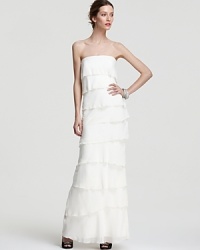 Tiers and tiers of rich silk decorate this Nicole Miller strapless gown for an ethereal look. Tiers and tiers of rich silk decorate this Nicole Miller strapless gown for an ethereal look.