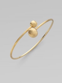 From the Africa Collection. Two textured orbs cross paths along a thin 18k yellow gold band.18k yellow gold Diameter, about 7 Made in Italy 