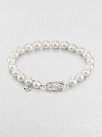 A lustrous strand of cultured pearls accented with a feminine 18k white gold clasp. 7mm-7.5mm round white cultured pearls18k white goldLength, about 7Butterfly closureImported 