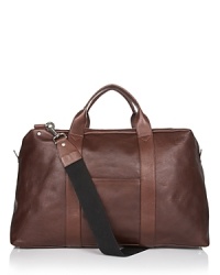 Soft grained leather duffel bag with zipper and top handles. Two slip pockets on each side. Interior pockets for organizing. Optional strap for carryon. Soft grained leather duffel bag with zipper and top handles. Two slip pockets on each side. Interior pockets for organizing. Optional strap for carryon.