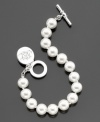 A stylish glass pearl (10 mm) toggle bracelet from Lauren by Ralph Lauren with a cute logo charm. Approximate length: 8 inches.