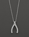 From the Tiny Treasures collection, a diamond wishbone necklace; with signature ruby accent. Designed by Roberto Coin.