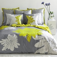 A graphic print in a high fashion palette, the Ashley Citron duvet set is a delightful twist on a Blilssliving Home favorite. Defying standard repeat patterns, our signature chrysanthemums are engineered in stunning scale. Crisp pure white and bright citron green bloom against a base of pewter grey. Matching pillow shams feature a unique double flange. Set reverses to solid grey color way. A graphic print in a high fashion palette, the Ashley Citron duvet set is a delightful twist on a Blilssliving Home favorite. Defying standard repeat patterns, our signature chrysanthemums are engineered in stunning scale. Crisp pure white and bright citron green bloom against a base of pewter grey. Matching pillow shams feature a unique double flange. Set reverses to solid grey color way.
