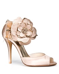An oversized flower adorns the ankle strap of Stuart Weitzman's statement-making Bodabing pumps. An oversized flower adorns the ankle strap of Stuart Weitzman's statement-making Bodabing pumps.