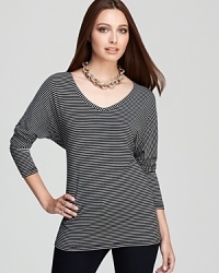 Sharp stripes adorn an effortless Isaac Mizrahi Jeans top, flaunting generous dolman sleeves for modern impact. Sharp stripes adorn an effortless Isaac Mizrahi Jeans top, flaunting generous dolman sleeves for modern impact.