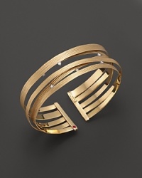 An elegant yellow gold cuff with scattered diamonds from Roberto Coin. An elegant yellow gold cuff with scattered diamonds from Roberto Coin.