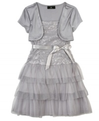 Beautiful glistening shrug tier dress by BCX with tiers of ruffles and accented with a ribbon waist. Beautiful glistening shrug tier dress by BCX with tiers of ruffles and accented with a ribbon waist.
