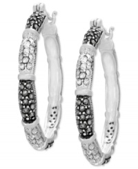 Genevieve & Grace sets an elegant tone. Its hoop earrings, set in sterling silver, dazzle with marcasite and crystals for a stylish statement. Approximate diameter: 1-1/2 inch. Genevieve & Grace sets an elegant tone. Its hoop earrings, set in sterling silver, dazzle with marcasite and crystals for a stylish statement. Approximate diameter: 1-1/2 inch.