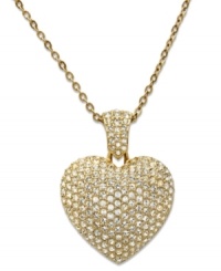Refined and romantic. Swarovski's puffed heart pendant stands out stylishly on this stunning necklace. Adorned with sparkling clear pavé crystals, it's crafted in gold tone mixed metal and includes a foldover clasp. Approximate length: 32 inches. Approximate drop: 1 inch. Refined and romantic. Swarovski's puffed heart pendant stands out stylishly on this stunning necklace. Adorned with sparkling clear pavé crystals, it's crafted in gold tone mixed metal and includes a foldover clasp. Approximate length: 32 inches. Approximate drop: 1 inch.