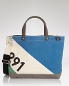 Featuring a cool color-block design with a printed number graphic, this tote is ideal for carrying to the beach and handles all your essentials for your trips downtown, too.