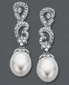 Update your jewelry box with a little glamour. These stunning, swirl-shaped drop earrings are adorned with round-cut diamonds (1/5 ct. t.w.) and cultured freshwater pearl drops (8 mm x 10 mm). Crafted in 14k white gold. Approximate drop: 1-1/4 inches.