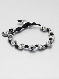 Knotted cord bracelet is interupted with impeccably sculpted skulls of sterling silver for a modern, masculine addition to your accessory collection.Sterling silverWaxed cottonDiameter, about 3Drawstring closureMade in USA