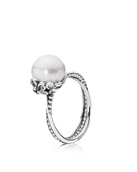 A white freshwater pearl rests in an elegant floral setting while delicately intertwined sterling silver bands complete the sweetly romantic look. Ring by PANDORA. A white freshwater pearl rests in an elegant floral setting while delicately intertwined sterling silver bands complete the sweetly romantic look. Ring by PANDORA.