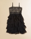 She'll shine like a star in this gorgeous frock with a pleated, metallic bodice and complimentary, cascading ruffled skirt.Straight necklineAdjustable spaghetti strapsPullover stylePleated bodiceJeweled waistbandRuffled skirtPolyesterHand washImported