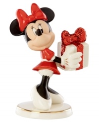 What a gift! A very beautiful Minnie Mouse delivers a sparkle-wrapped surprise for someone special in this magical Disney figurine by Lenox. What a gift! A very beautiful Minnie Mouse delivers a sparkle-wrapped surprise for someone special in this magical Disney figurine by Lenox.