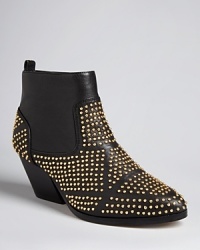 Dolce Vita adds interest to a sleek, minimalist Western silhouette in these must-have booties peppered with a galaxy of goldtone studs. Dolce Vita adds interest to a sleek, minimalist Western silhouette in these must-have booties peppered with a galaxy of goldtone studs.