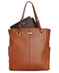 A classic Calvin Klein tote takes on the tech trend with a chic signature iPad case included within. Buttery-soft leather and polished hardware adorn the elegant shape, while the inside is outfitted with plenty of compartments to stow all your day-to-day essentials. A classic Calvin Klein tote takes on the tech trend with a chic signature iPad case included within. Buttery-soft leather and polished hardware adorn the elegant shape, while the inside is outfitted with plenty of compartments to stow all your day-to-day essentials.