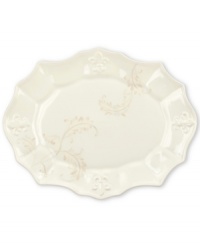 With embossed lilies and golden leaves, Portmeirion's decorated Fleur de Lys serving platter sets tables in the French tradition. Classic, scalloped stoneware in warm ivory lends distinct old-world elegance to everyday dining. With embossed lilies and golden leaves, Portmeirion's decorated Fleur de Lys serving platter sets tables in the French tradition. Classic, scalloped stoneware in warm ivory lends distinct old-world elegance to everyday dining.