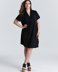 Exercise restrained minimalism with this Calvin Klein Plus tee shirt dress. An elegant knotted neckline finishes a clean silhouette for a versatile closet essential. Exercise restrained minimalism with this Calvin Klein Plus tee shirt dress. An elegant knotted neckline finishes a clean silhouette for a versatile closet essential.
