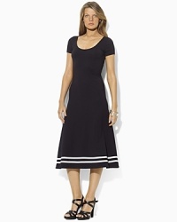 A timeless dress is rendered in a soft Pima cotton blend and finished with a flared skirt for a modern silhouette. A timeless dress is rendered in a soft Pima cotton blend and finished with a flared skirt for a modern silhouette.