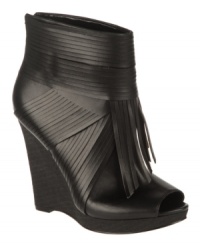 Walking in a Western wonderland. Decked out in fringe with a zipper up the back, the Curious wedge booties from Carlos by Carlos Santana are a trendy upgrade to a classic. Walking in a Western wonderland. Decked out in fringe with a zipper up the back, the Curious wedge booties from Carlos by Carlos Santana are a trendy upgrade to a classic.
