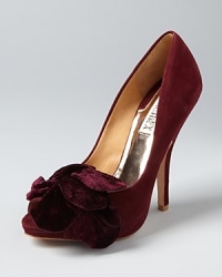 Sophisticated velvet bows add polished style to these soft, suede Badgley Mischka evening pumps. They work during the day as well, lending elegance to workday sets and separates. Sophisticated velvet bows add polished style to these soft, suede Badgley Mischka evening pumps. They work during the day as well, lending elegance to workday sets and separates.