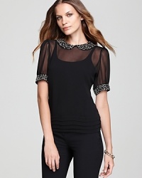 So cool it hurts, this VINCE CAMUTO blouse takes a tame silhouette and jazzes it up with jeweled embellishment and sheer styling for the perfect punk-meets-prep mix. So cool it hurts, this VINCE CAMUTO blouse takes a tame silhouette and jazzes it up with jeweled embellishment and sheer styling for the perfect punk-meets-prep mix.