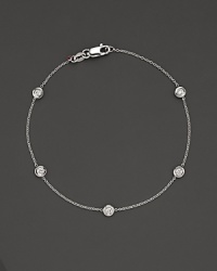 White gold bezel-set diamond cluster bracelet. With signature ruby accent. Designed by Roberto Coin. White gold bezel-set diamond cluster bracelet. With signature ruby accent. Designed by Roberto Coin.