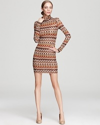 In a vibrant flamestitch pattern, ABS by Allen Schwartz's jersey knit dress lends a throwback look in a long sleeved, turtleneck silhouette. In a vibrant flamestitch pattern, ABS by Allen Schwartz's jersey knit dress lends a throwback look in a long sleeved, turtleneck silhouette.
