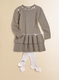 With bows woven through at the neck and waist, a mother-of-pearl adornment and two tiers of ruffles, this soft sweater dress is anything but ordinary.CrewneckLong sleevesPull-on styleTiered, ruffled skirt80% cotton/20% cashmereMachine washMade in France With bows woven through at the neck and waist, a mother-of-pearl adornment and two tiers of ruffles, this soft sweater dress is anything but ordinary.CrewneckLong sleevesPull-on styleTiered, ruffled skirt80% cotton/20% cashmereMachine washMade in France