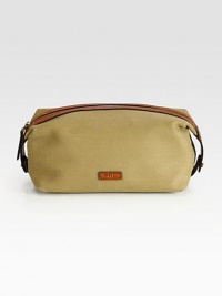 An impeccably stylish carrying case for the modern gentleman, this lightweight pouch in a leather-trimmed canvas construction provides sharp transport for essential toiletries.Zip closureInterior zip pocketAntiqued brass hardwareEmbossed leather logo accents the exteriorCanvas9W x 5HImported An impeccably stylish carrying case for the modern gentleman, this lightweight pouch in a leather-trimmed canvas construction provides sharp transport for essential toiletries.Zip closureInterior zip pocketAntiqued brass hardwareEmbossed leather logo accents the exteriorCanvas9W x 5HImported