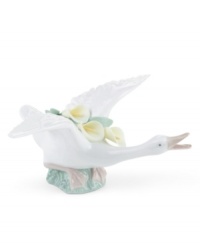 Spreading its wings with yellow calla lilies in tow, this elegant duck is poised to take flight in lustrous Lladro porcelain. Spreading its wings with yellow calla lilies in tow, this elegant duck is poised to take flight in lustrous Lladro porcelain.
