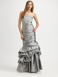 This head-turning style brings the drama with pleated details, jeweled beading, and a sculptural trumpet skirt.StraplessPleated bodiceBeaded waistbandRuched trumpet skirt with asymmetrical pick-up detailConcealed side zipTaffeta liningAbout 42 from natural waistPolyesterDry cleanImportedModel shown is 5'10 (177cm) wearing US size 4. This head-turning style brings the drama with pleated details, jeweled beading, and a sculptural trumpet skirt.StraplessPleated bodiceBeaded waistbandRuched trumpet skirt with asymmetrical pick-up detailConcealed side zipTaffeta liningAbout 42 from natural waistPolyesterDry cleanImportedModel shown is 5'10 (177cm) wearing US size 4.