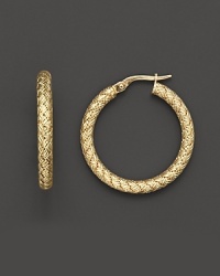 Bold, chunky gold hoops gain elegant distinction with an embossed basketweave pattern. Bold, chunky gold hoops gain elegant distinction with an embossed basketweave pattern.