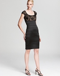 This body-skimming Tadashi Shoji dress shows off your silhouette with a beaded lace bodice and a banded skirt. This body-skimming Tadashi Shoji dress shows off your silhouette with a beaded lace bodice and a banded skirt.