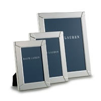 Smooth, shining silver-plated brass is decorated with a simple embossed design at each corner in this effortlessly elegant frame from Ralph Lauren Home. Smooth, shining silver-plated brass is decorated with a simple embossed design at each corner in this effortlessly elegant frame from Ralph Lauren Home.